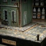 WWII diorama with cobblestone road and building by Scale Wonderland